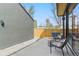 Back patio with two chairs, two side tables, concrete and rock at 3047 S Cherokee St, Englewood, CO 80110