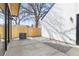 Concrete patio with stone trim, AC unit and wood fence, providing a private outdoor space at 3047 S Cherokee St, Englewood, CO 80110