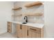 Stylish wet bar featuring a counter and floating shelves at 3047 S Cherokee St, Englewood, CO 80110