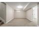 A carpeted basement space that is recently painted and ready to be customized as a rec room at 118 S Dale Ct, Denver, CO 80219