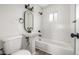 Updated bathroom featuring modern fixtures, a pedestal sink, and tiled shower at 118 S Dale Ct, Denver, CO 80219