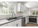 Charming kitchen featuring white cabinetry, modern countertops and stainless steel appliances at 118 S Dale Ct, Denver, CO 80219