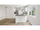 Charming kitchen featuring white cabinetry, modern countertops and stainless steel appliances at 118 S Dale Ct, Denver, CO 80219