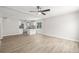 Bright living room featuring modern flooring, fresh paint, open concept to kitchen and natural light at 118 S Dale Ct, Denver, CO 80219
