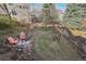Backyard features mature trees, firepit and wooden swing at 10572 Jaguar Gln, Lone Tree, CO 80124
