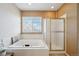 Bathroom with a large soaking tub, a glass-enclosed shower, and neutral decor; promotes relaxation and comfort at 10572 Jaguar Gln, Lone Tree, CO 80124
