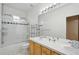 Bathroom with double sinks, a shower with glass doors, and bright lighting at 10572 Jaguar Gln, Lone Tree, CO 80124