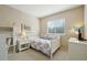 Cozy bedroom featuring a white bed frame, plush carpet, and bright natural light at 10572 Jaguar Gln, Lone Tree, CO 80124