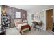 Stylish bedroom with unique wallpaper, a comfortable bed, and a dedicated desk area at 10572 Jaguar Gln, Lone Tree, CO 80124