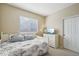Comfortable bedroom featuring a white bed frame and natural light from a window at 10572 Jaguar Gln, Lone Tree, CO 80124