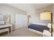 Bright bedroom features a bed with storage drawers, closet and dressing table at 10572 Jaguar Gln, Lone Tree, CO 80124