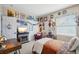 A vibrant bedroom showcasing eclectic decor, a cozy fireplace, and a relaxing reading nook, offering a unique personal touch at 10572 Jaguar Gln, Lone Tree, CO 80124