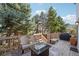 Outdoor deck with fire pit table, patio furniture, and grill at 10572 Jaguar Gln, Lone Tree, CO 80124