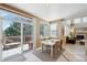 Bright dining area with sliding glass doors to a deck and an open layout flowing into the living room at 10572 Jaguar Gln, Lone Tree, CO 80124