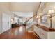 Welcoming entryway featuring hardwood floors, an open view to the living area, and a staircase bathed in natural light at 10572 Jaguar Gln, Lone Tree, CO 80124
