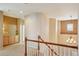Hallway boasts wood railing, neutral paint, and a chandelier at 10572 Jaguar Gln, Lone Tree, CO 80124