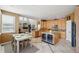 Spacious kitchen featuring an island with a wine fridge, custom cabinets, and an open layout at 10572 Jaguar Gln, Lone Tree, CO 80124