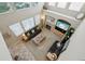 High-angle view of living room with vaulted ceiling, fireplace, and comfortable seating at 10572 Jaguar Gln, Lone Tree, CO 80124