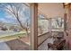 Inviting front porch with comfortable wicker furniture, perfect for enjoying the neighborhood views and the shade of mature trees at 10572 Jaguar Gln, Lone Tree, CO 80124