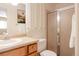 Bright bathroom featuring a shower with glass door and a vanity at 654 S Xenon Ct, Lakewood, CO 80228