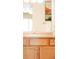 Bathroom featuring a sink with vanity, mirror, and cabinet storage at 654 S Xenon Ct, Lakewood, CO 80228