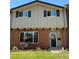 Charming two-story townhouse with brick facade, gray wood siding and a well-maintained front lawn at 654 S Xenon Ct, Lakewood, CO 80228