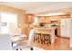 Bright kitchen and dining area, featuring light wood cabinets and island seating at 654 S Xenon Ct, Lakewood, CO 80228