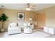 Neutral-toned living room with plush seating and a view into the next room at 654 S Xenon Ct, Lakewood, CO 80228