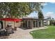 Large backyard with a brick patio, dining set, grill, grassy area, and an enclosed sunroom at 1164 W 101St Pl, Northglenn, CO 80260