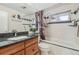 Bathroom featuring a granite vanity, shower-tub combo, and elegant tile accents at 1164 W 101St Pl, Northglenn, CO 80260