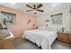 Comfortable bedroom with a queen-sized bed, ceiling fan, neutral paint and two windows for natural light at 1164 W 101St Pl, Northglenn, CO 80260