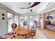 Bright dining area with large windows, tile floor and rustic wood table with unique cowhide-patterned chairs at 1164 W 101St Pl, Northglenn, CO 80260