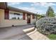 Inviting entrance featuring a brick facade, well-manicured shrubbery, and a step-up pathway, creating a welcoming approach at 1164 W 101St Pl, Northglenn, CO 80260
