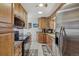 Functional kitchen featuring wood cabinets, stainless steel appliances, and ample counter space for meal preparation at 1164 W 101St Pl, Northglenn, CO 80260