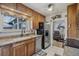 Well-equipped kitchen with wood cabinetry, stainless steel refrigerator, and granite countertops offering a stylish and functional space at 1164 W 101St Pl, Northglenn, CO 80260