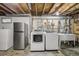 Laundry room with a full-sized washer and dryer, utility sink, and extra refrigerator space at 1164 W 101St Pl, Northglenn, CO 80260