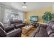 Bright living room with hardwood floors, providing a warm and inviting atmosphere with comfortable seating and natural light at 1164 W 101St Pl, Northglenn, CO 80260