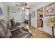 Open-concept living space with hardwood floors, seamlessly connecting the sitting area with a view of the kitchen at 1164 W 101St Pl, Northglenn, CO 80260