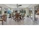 Bright sun room with tiled floors, large windows overlooking the backyard, and a dining area for entertaining at 1164 W 101St Pl, Northglenn, CO 80260