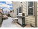 Back patio with grill and outdoor seating in snow at 2184 Willow Ct, Denver, CO 80238