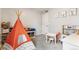 Playful bedroom features a modern teepee, play kitchen, and animal prints at 2184 Willow Ct, Denver, CO 80238