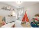 Bright bedroom featuring a modern teepee, a white dresser, and toys at 2184 Willow Ct, Denver, CO 80238