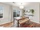 Dining area features modern lighting, a dining table and bench, floating wall shelves, and hardwood flooring at 2184 Willow Ct, Denver, CO 80238