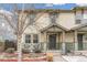 Charming townhouse featuring a covered front porch, well-kept landscaping, and neutral color palette at 2184 Willow Ct, Denver, CO 80238