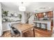 Open concept kitchen and dining room features stainless steel appliances, island seating, and hardwood floors at 2184 Willow Ct, Denver, CO 80238