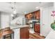 Charming kitchen with stainless steel appliances, cherry wood cabinets, granite countertops, and island seating at 2184 Willow Ct, Denver, CO 80238