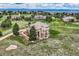 Majestic aerial view of a sprawling estate with a lush green lawn, mature trees, and beautiful landscaping at 6411 Sand Rose Ct, Castle Rock, CO 80108