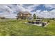Expansive backyard featuring a patio with outdoor seating, an umbrella and sprawling green lawn, perfect for entertaining at 6411 Sand Rose Ct, Castle Rock, CO 80108