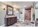 Bathroom with a large framed mirror, brown vanity, and a tiled walk-in shower at 6411 Sand Rose Ct, Castle Rock, CO 80108
