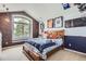 Charming bedroom featuring a brick wall, large window, and sports themed decor at 6411 Sand Rose Ct, Castle Rock, CO 80108